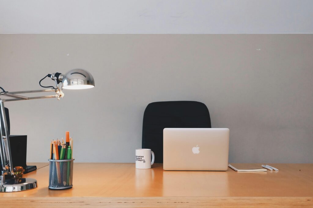 pexels photo 265072 265072 A tidy minimalist office setup featuring a laptop, desk lamp, and stationery.